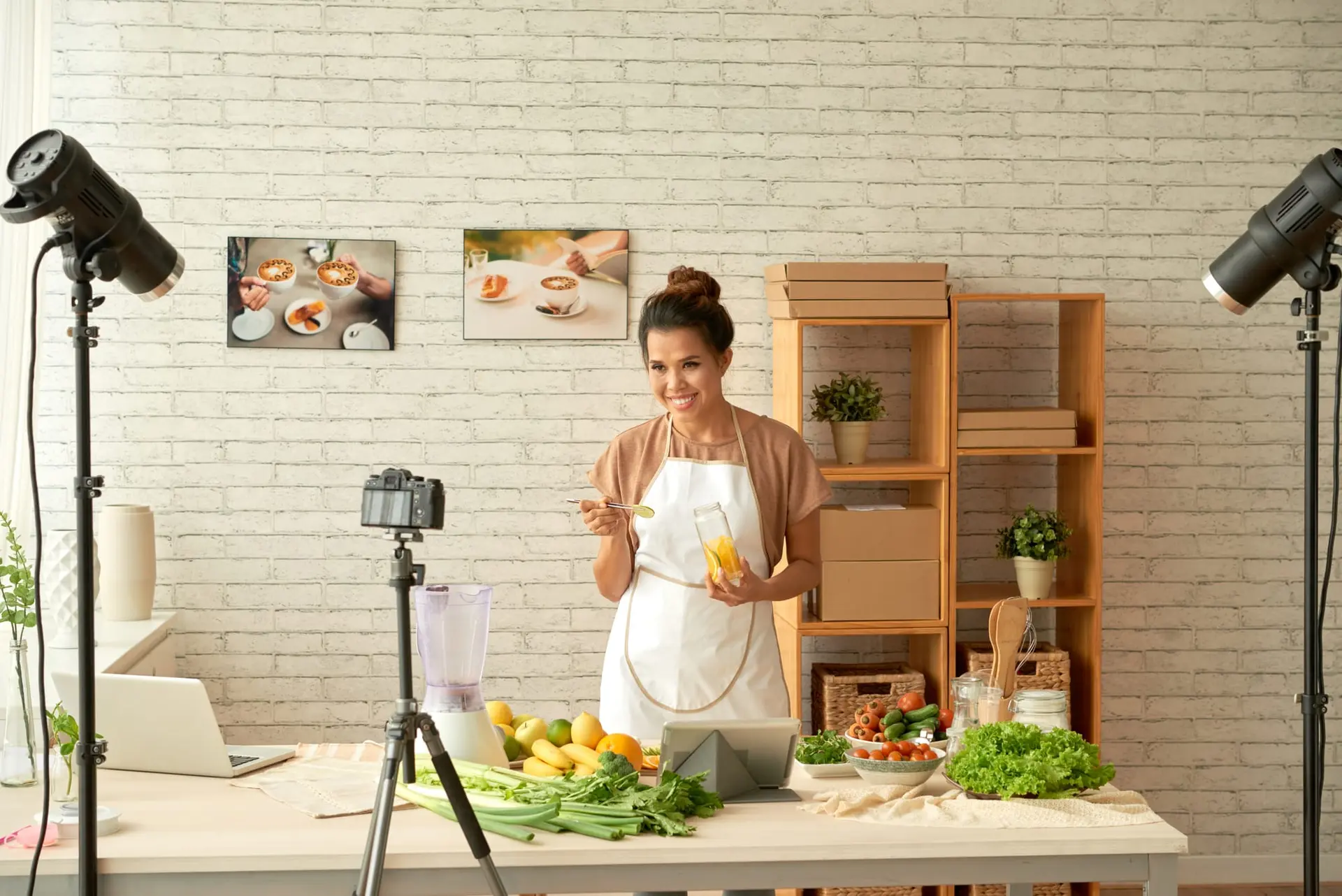 Food content shoot with studio lights and a camera filming a woman cooking