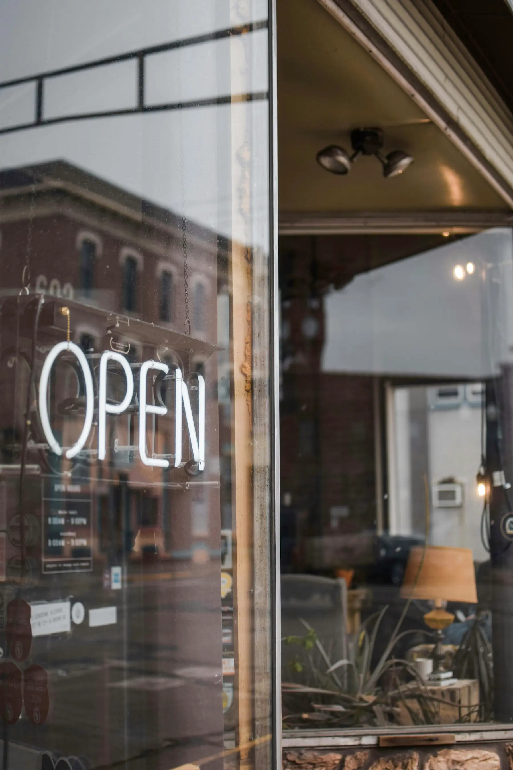 Illuminated OPEN sign in the window of a local storefront
