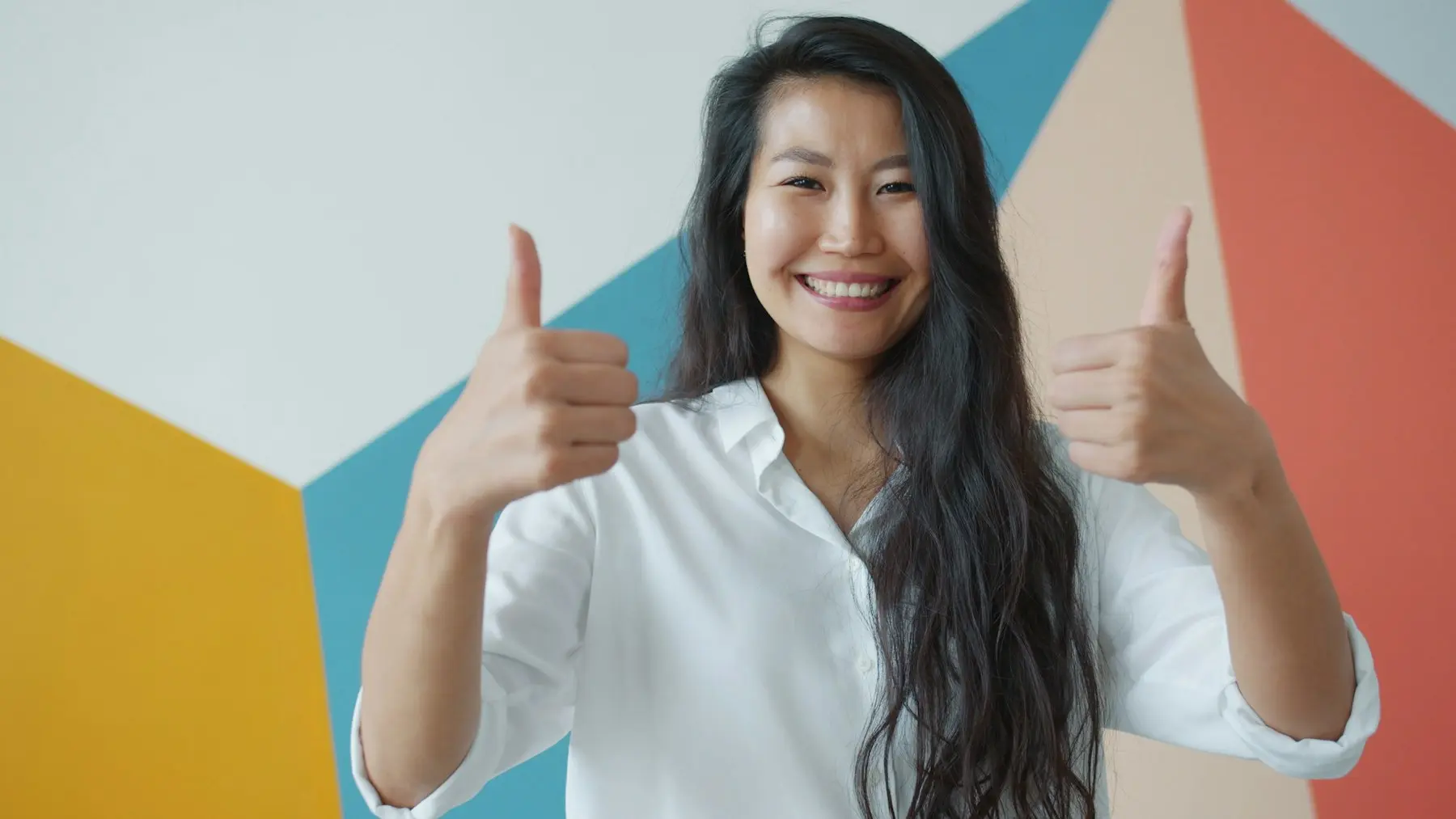 Smiling customer giving two thumbs up