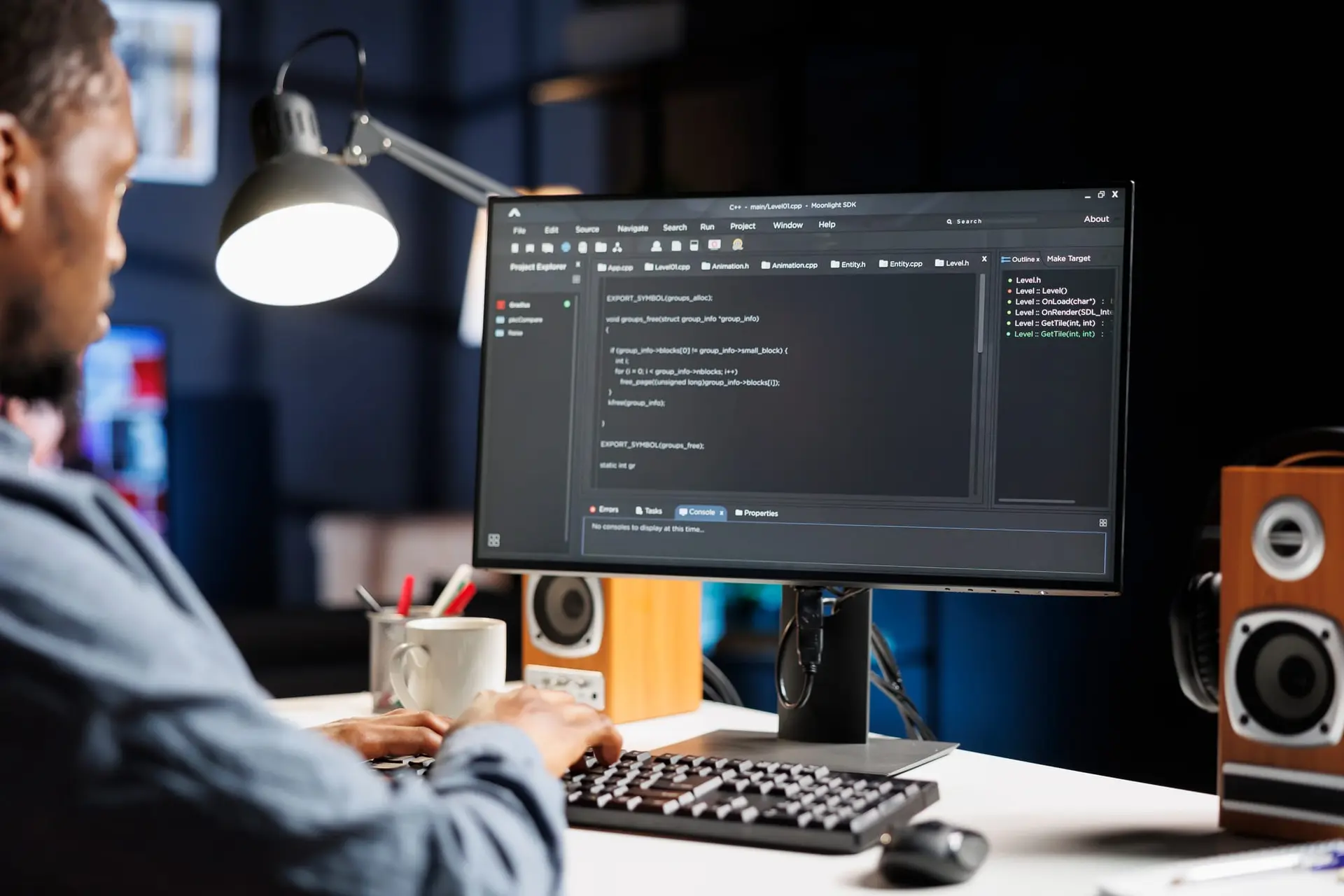 Web developer writing HTML code on a desktop monitor